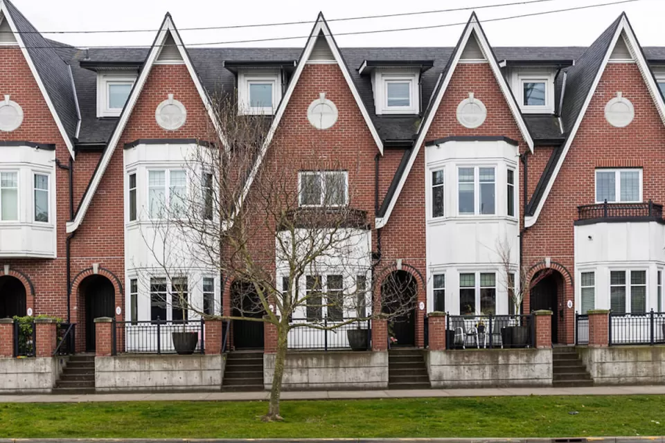 Row of brick three-story townhomes in Britih Columbia.